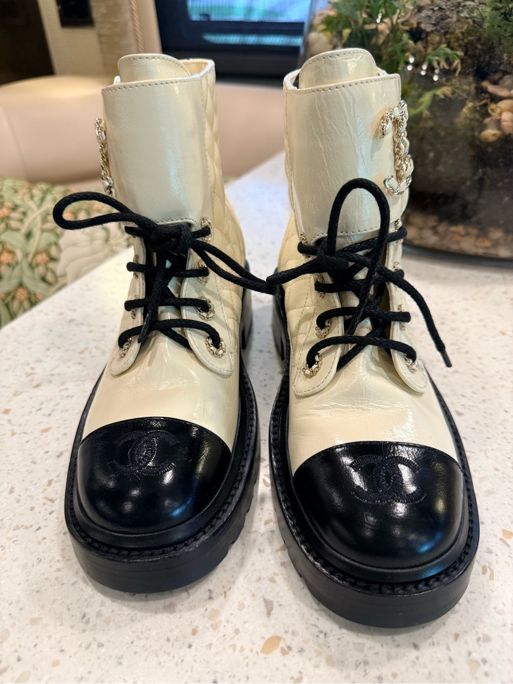 CHANEL Cream and Black Lace-Up Quilted Combat Boots with Gold Chain